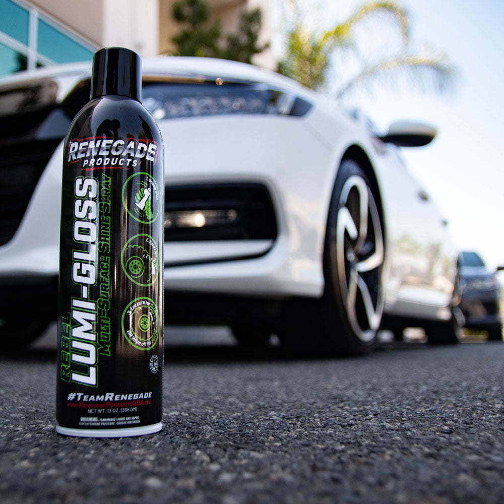 Bottle of Renegade Lumi-Gloss Multi-Surface Shine Spray for vehicles, showcasing its glossy finish on various surfaces.