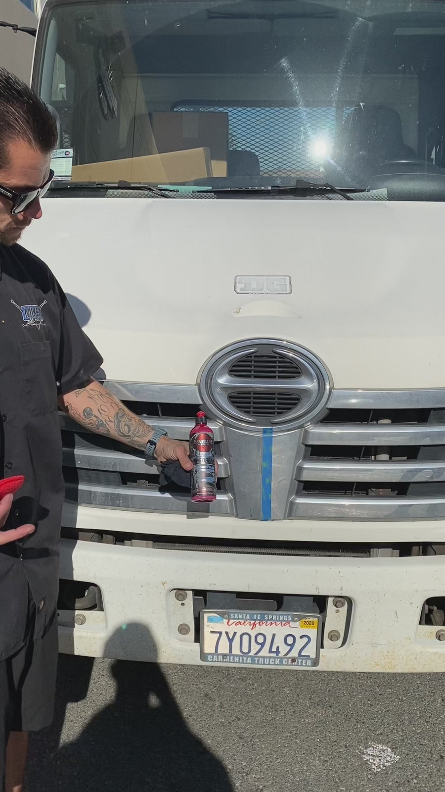 Applying Pipe Dream Chrome Conditioner and Polish to a truck grille emblem