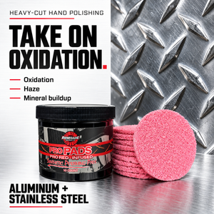 Renegade Pro Pads jar and pink pads against diamond plate; graphic promotes heavy-cut hand polishing for oxidation, haze and mineral buildup on aluminum and stainless steel.