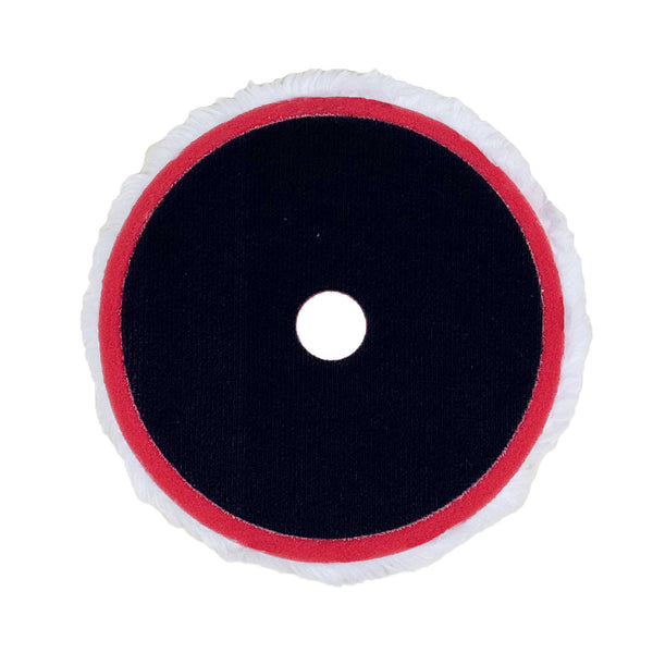 Synthetic wool polishing pads attached to a rotary machine, ideal for metal and paint restoration projects.