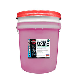 Bottle of Glass Magic Concentrated Glass Cleaner with a waffle weave towel, ideal for cleaning glass surfaces without streaks.